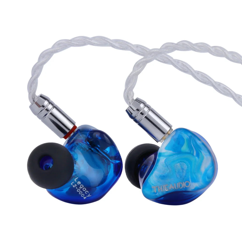 Blue translucent thieaudio legacy hybrid in-ear monitor with silver connectors and black silicone tips for audiophiles musicians