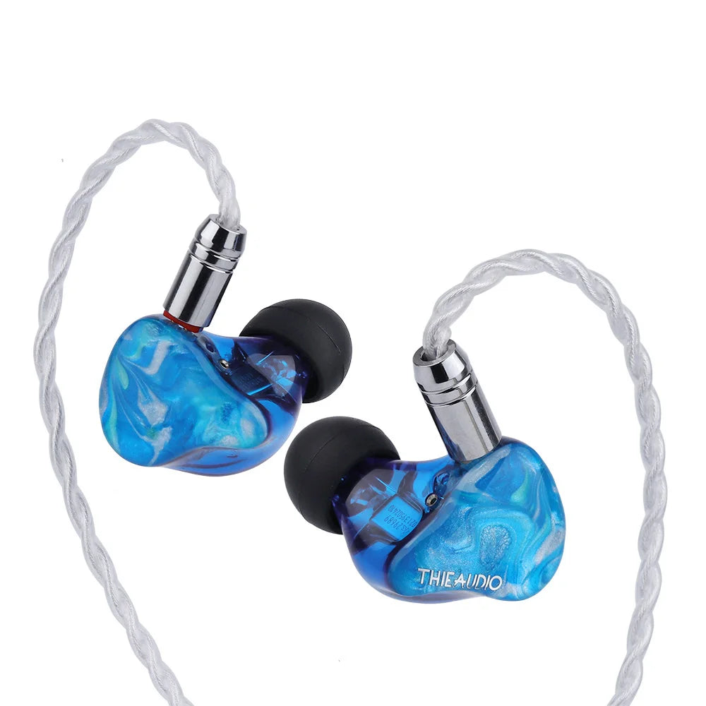 Blue translucent marble-patterned thieaudio legacy hybrid in-ear monitor with silver connectors for audiophiles musicians