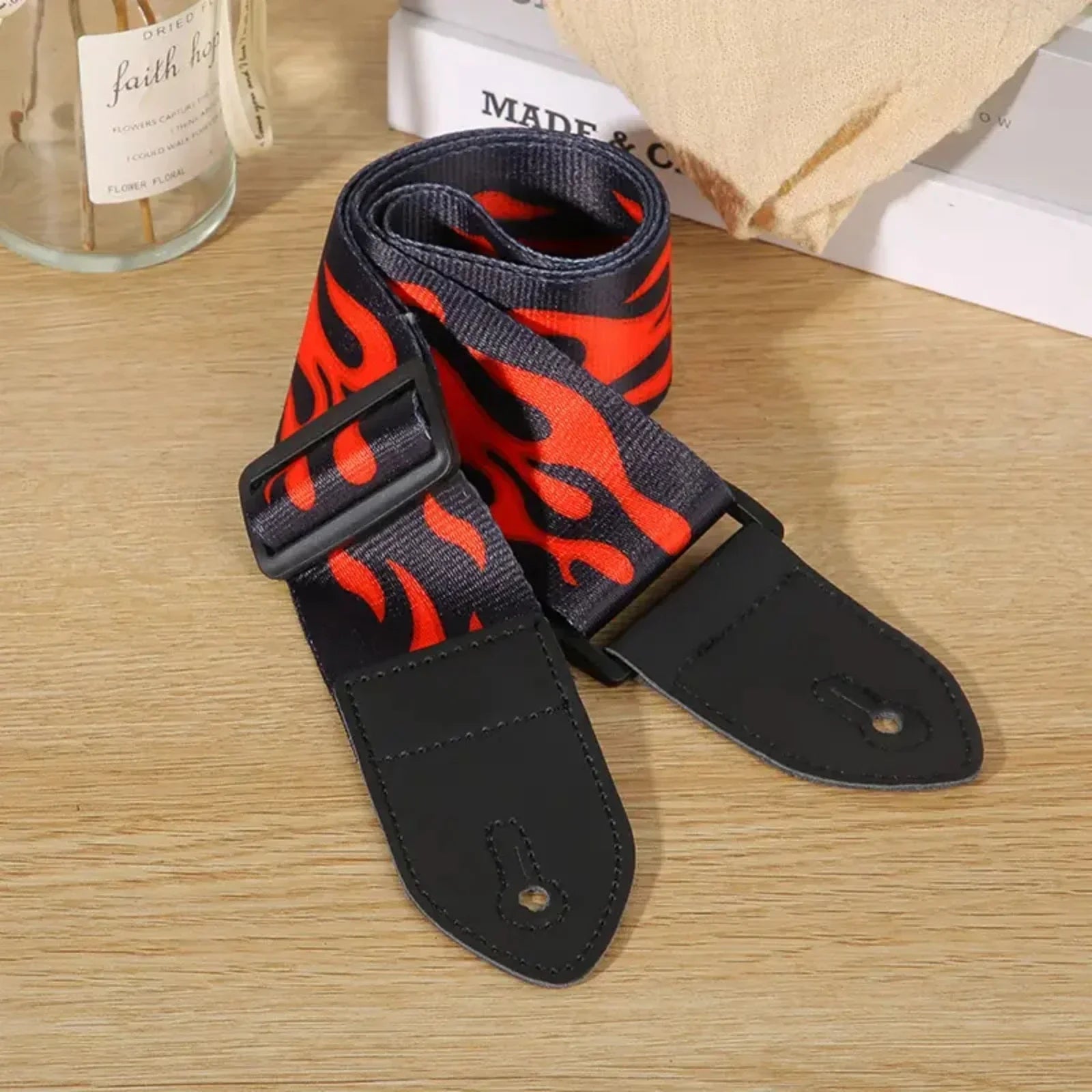 Black and orange flame-patterned leather guitar strap with premium woodgrain leather and adjustable buckle fits classical electric