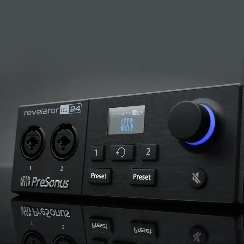 Black presonus revelator io24 usb sound card with glowing blue knob and two xlr inputs for live recording controller use