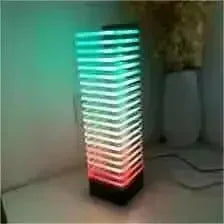A sleek product manufacturer desk tower voice control LED lamp glowing in teal and red gradient vertical strips
