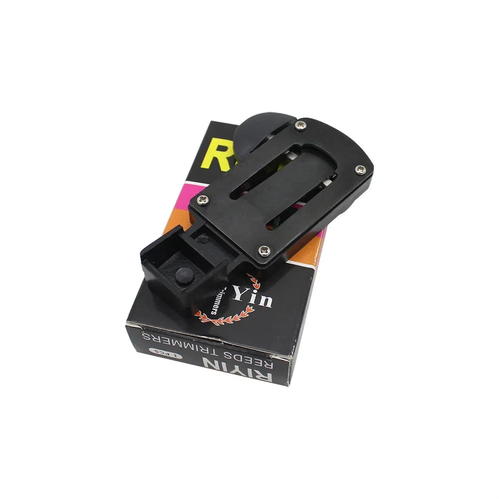 Black plastic bike pedal clip with four silver screws and central slot for keys bb clarinet accessories reed box cleaning brushes trimmer