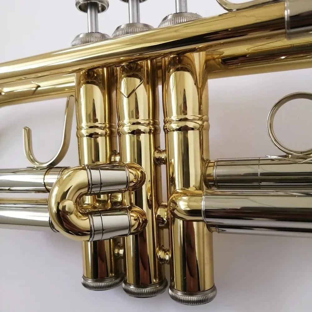 Professional bb trumpet with shiny gold and silver brass polished tubing and valve casings for beat music store use