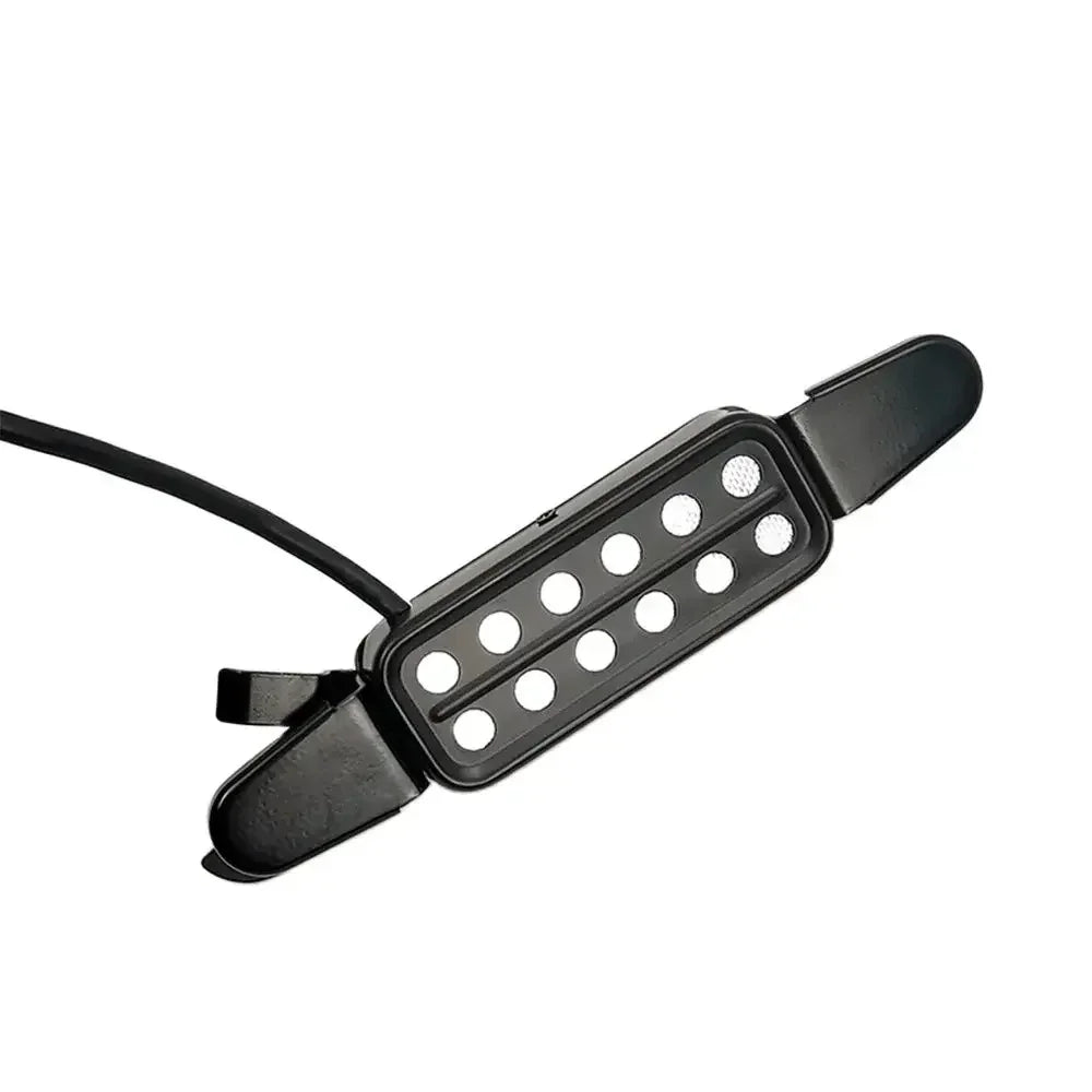 Black plastic acoustic guitar pickup transducer with ten circular holes and wire for pickup transducer amplifier use