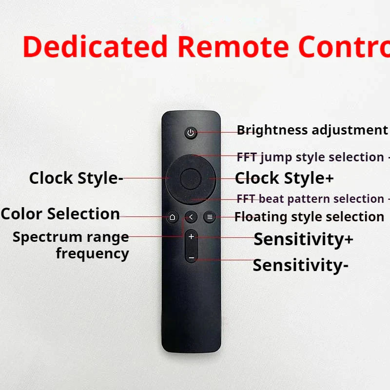 Black plastic remote control with circular pad and buttons for brightness and color on professional music spectrum display instrument