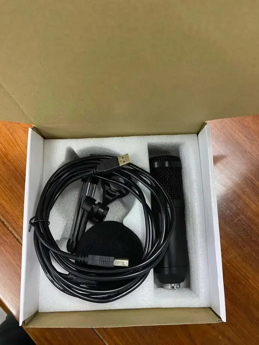 Black professional usb condenser microphone with mesh grille and foam windscreen in white foam for laptop pc live recording