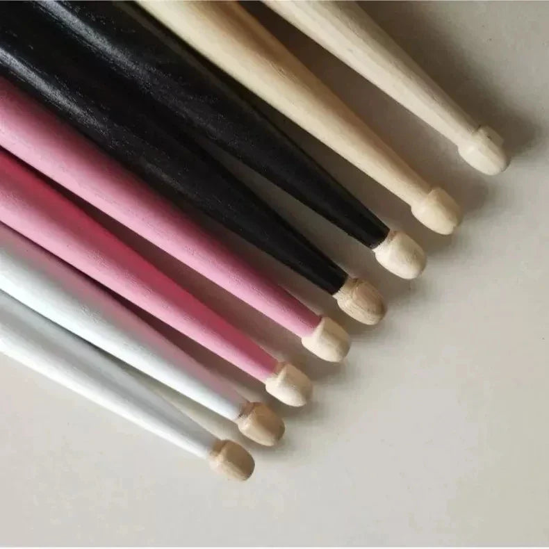 A set of professional vic firth drumsticks in natural wood black pink and white hickory for jazz rock durable use