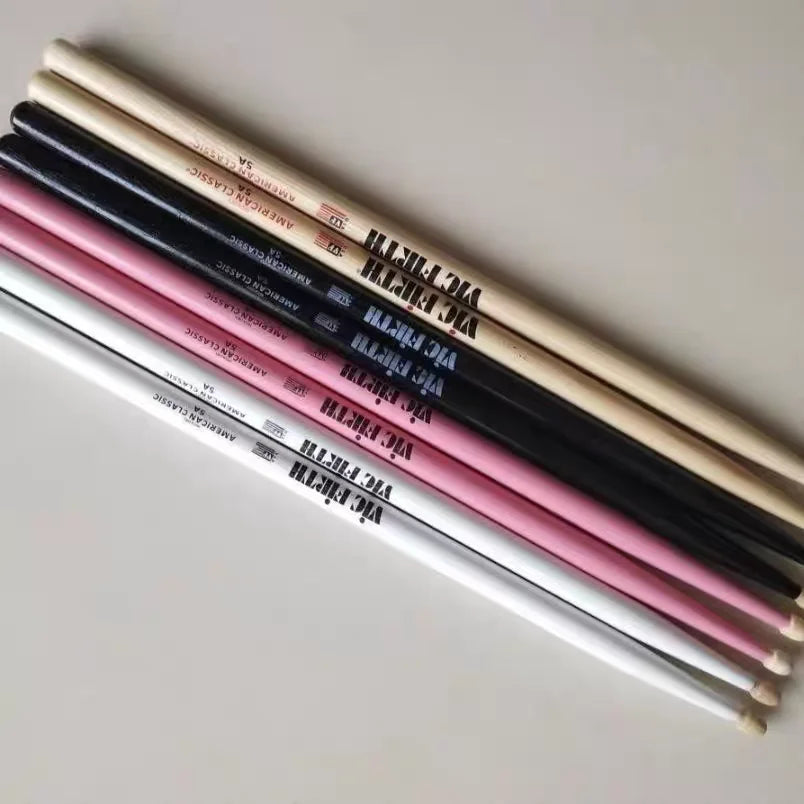 Set of six professional vic firth drumsticks in natural wood black pink and white finishes for jazz rock durable use