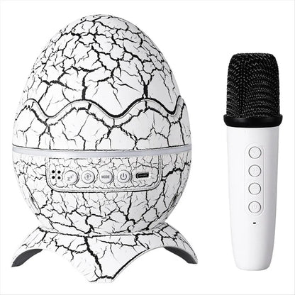 White egg-shaped karaoke bluetooth speaker with black crackle pattern and silver panel with white microphone for outdoor camping atmosphere light projection