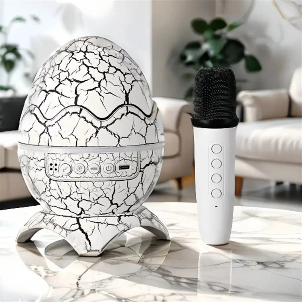 White egg-shaped karaoke bluetooth speaker with black crackle design silver control panel and white microphone for outdoor camping atmosphere light projection