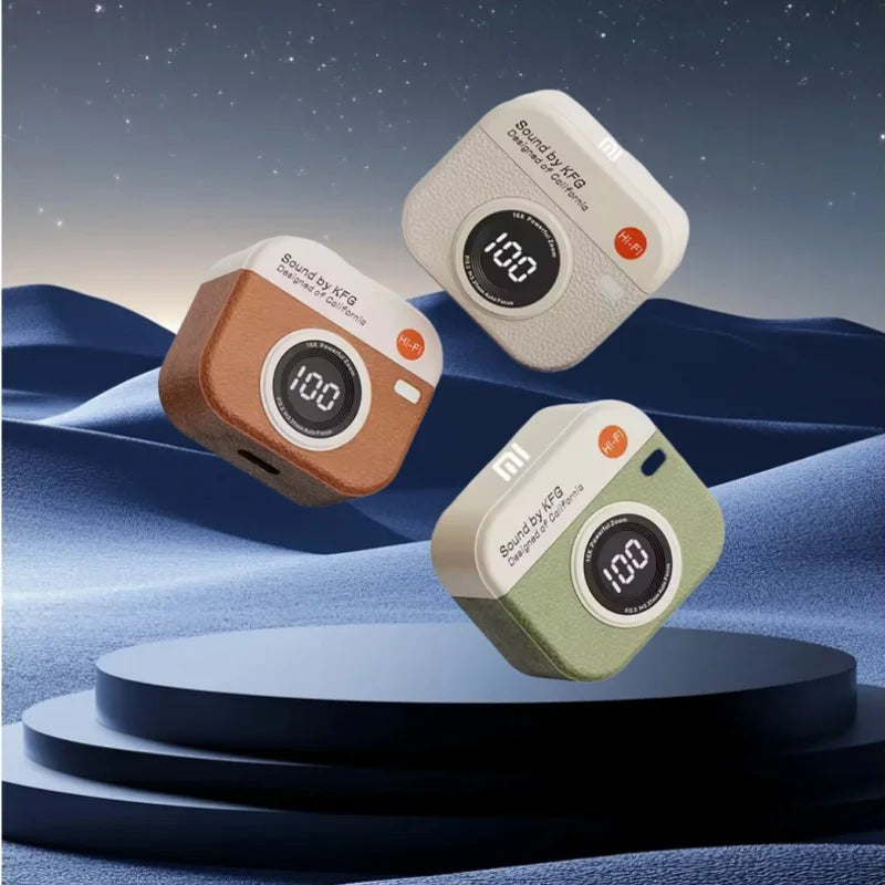 Three compact camera-shaped q86 bluetooth 5.3 wireless speakers in beige brown and olive green with textured finish