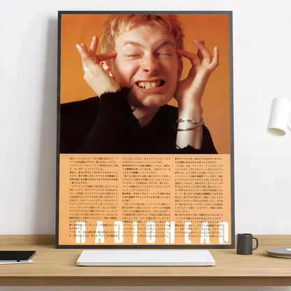 Black-framed hd canvas poster of smiling man with blonde hair and white shirt on orange background for living room decor with lighting effects
