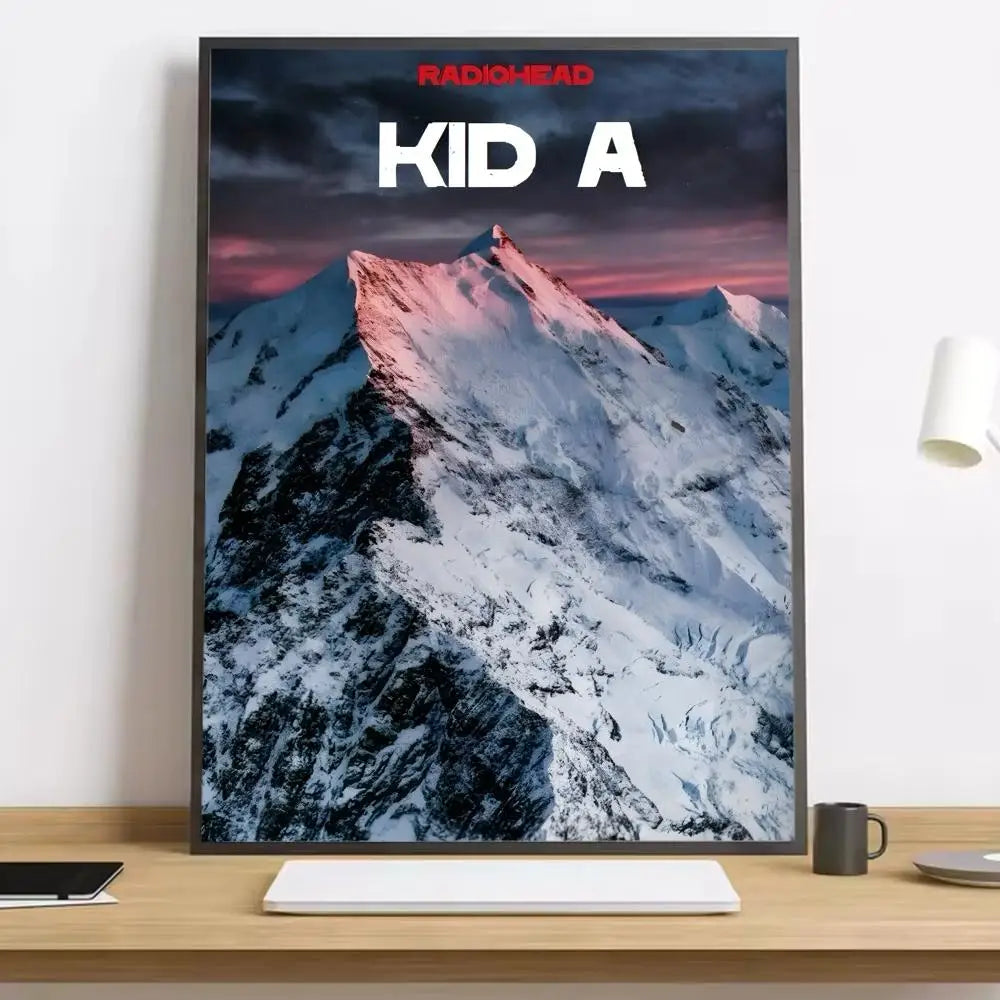 A framed kid a radiohead band poster with snow-capped mountains on matte paper in black frame with lighting effects for living rooms