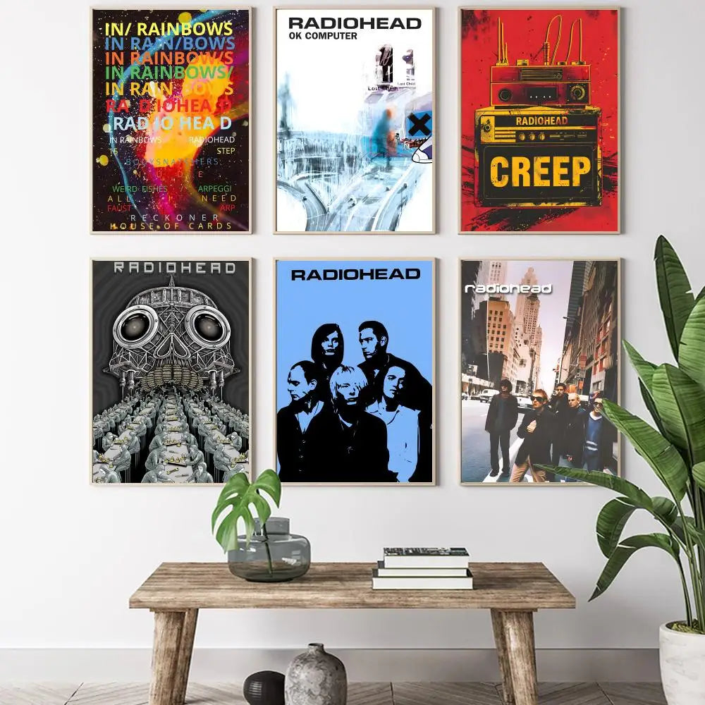 Six framed radiohead album posters with vibrant lighting effects above rustic wooden table for living room decor