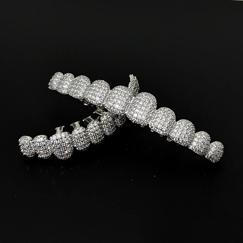 Icy white diamond-encrusted RACHELZ stone teeth grillz with sleek metallic silver zirconia tooth caps for grillz punk rapper style