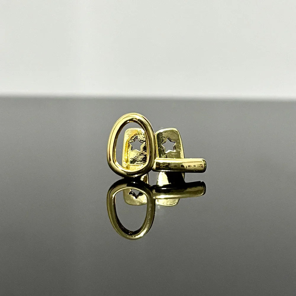 Gold-toned cufflinks with star-shaped cutout design complement hip hop gold teeth and silver teeth grillz jewelry