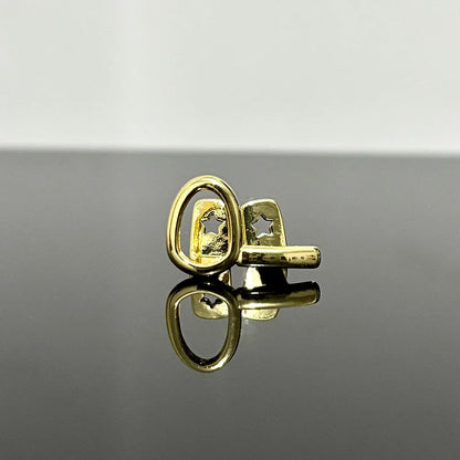 Gold-toned cufflinks with star-shaped cutout design complement hip hop gold teeth and silver teeth grillz jewelry