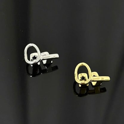 A pair of rachelz minimalist key-shaped stud earrings in polished silver and gold-tone metal with star cutouts for stylish gold teeth care products