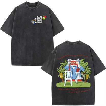 Black oversized rapper bad bunny dtmf t shirt with faded texture and vibrant prints of cartoon man taking photos in tropical setting