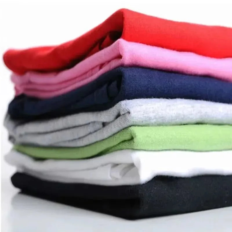 Stack of neatly folded solid-colored casual loose cotton rapper bad bunny merch t-shirts in various colors for men and women