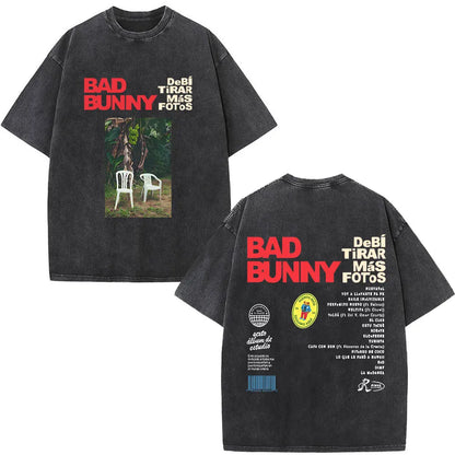 Black oversized rapper bad bunny t shirt with faded white chairs under banana trees and bold red debi tirar mas dtmf world tour text
