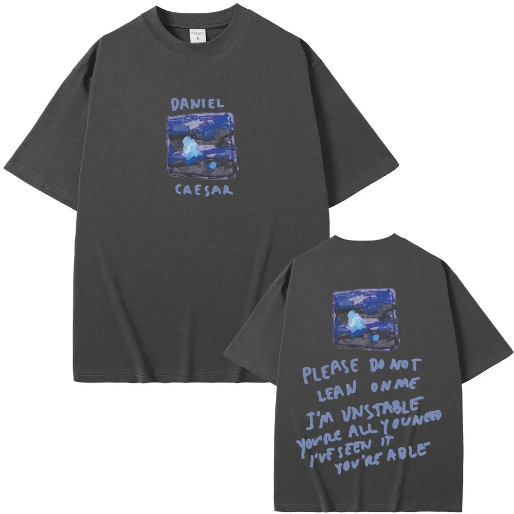 Dark gray oversized t-shirt with blue abstract graphic and daniel caesar text, featuring lyric quote on back for women hip hop fashion