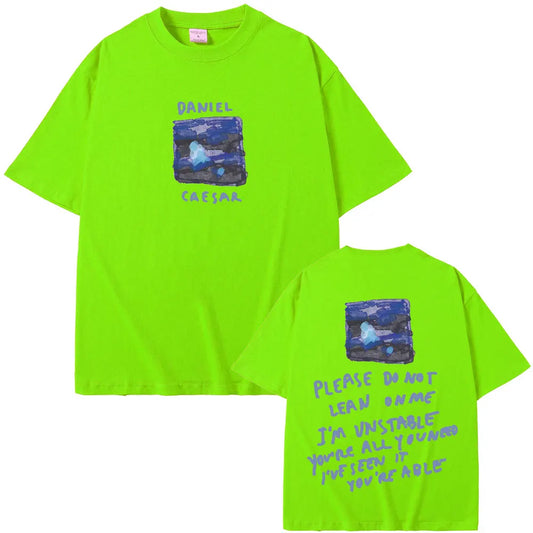 Bright neon green oversized t-shirt with blue black graphic and daniel caesar lyrics for women hip hop fashion