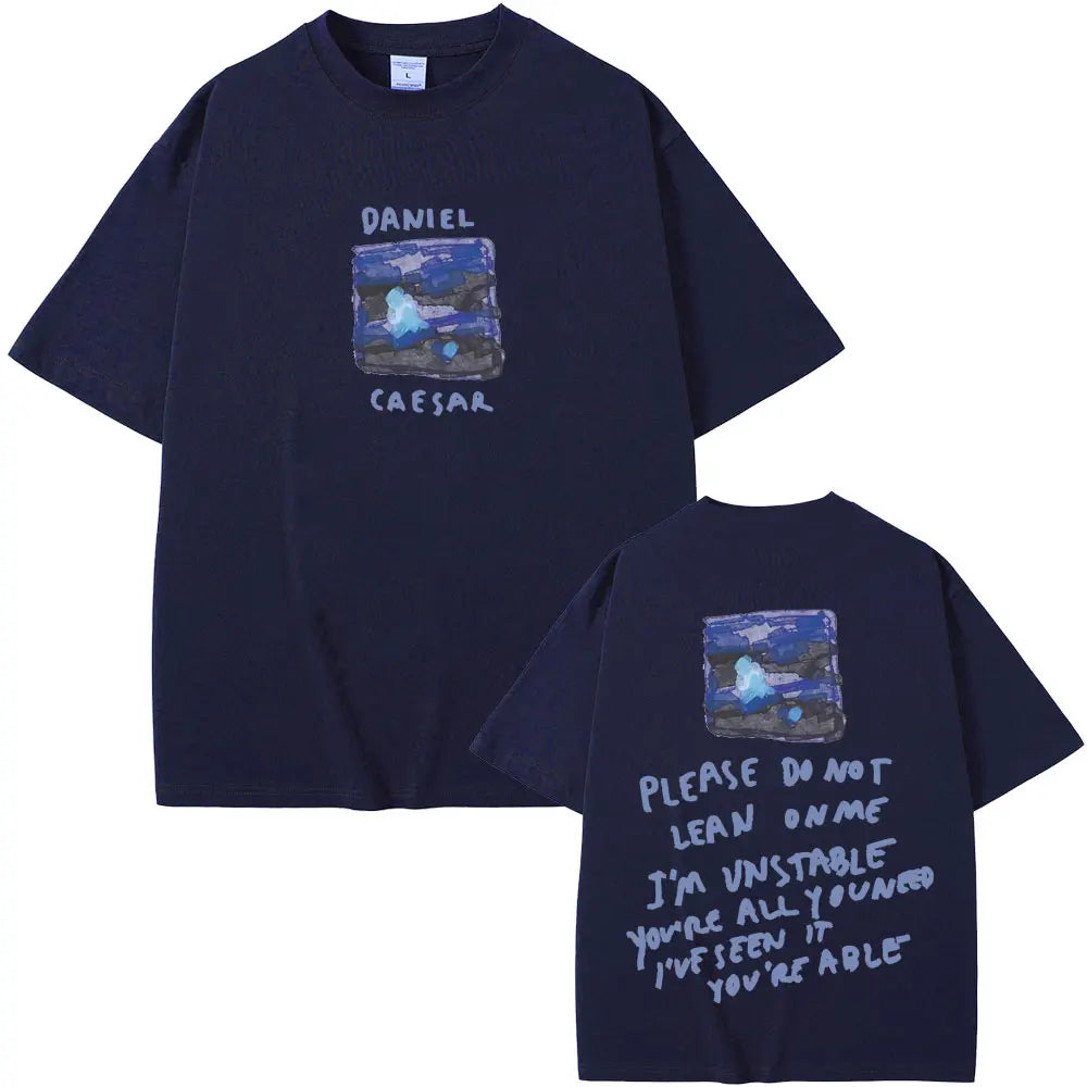 Dark navy blue oversized t-shirt with abstract blue and purple graphic labeled daniel caesar for hip hop fashion women