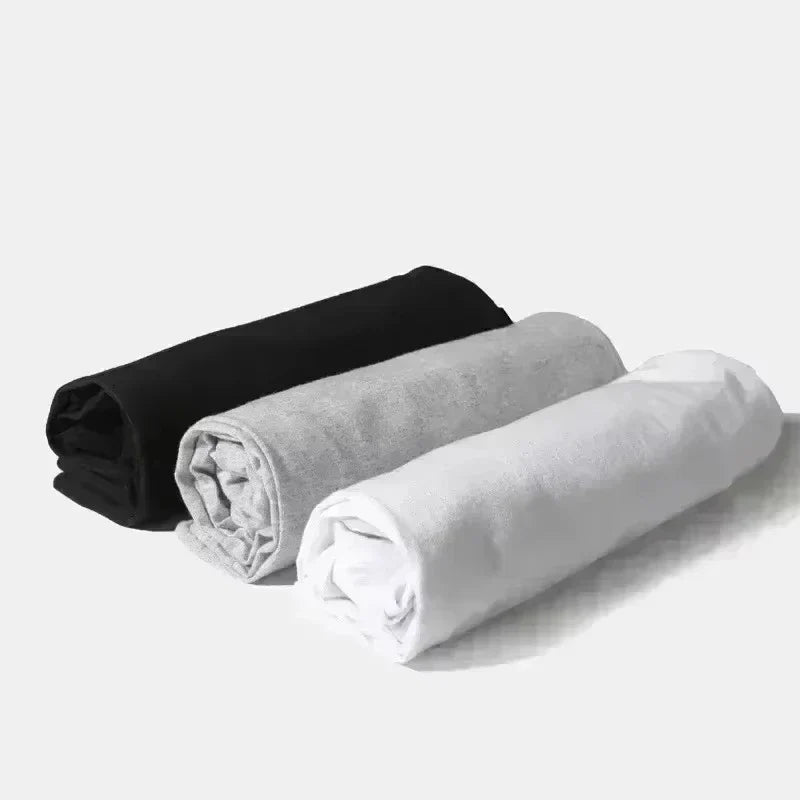 Three rolled-up soft plush fabric items in black gray and white for rapper frank retro hop ocean album blond fashion oversized tshirt