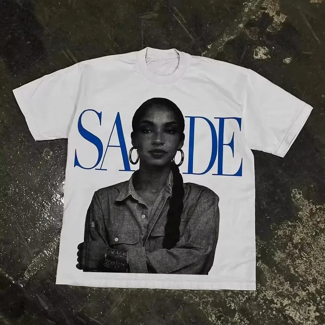White cotton t-shirt featuring black and white sade portrait with bold blue lettering in rapper frank retro style