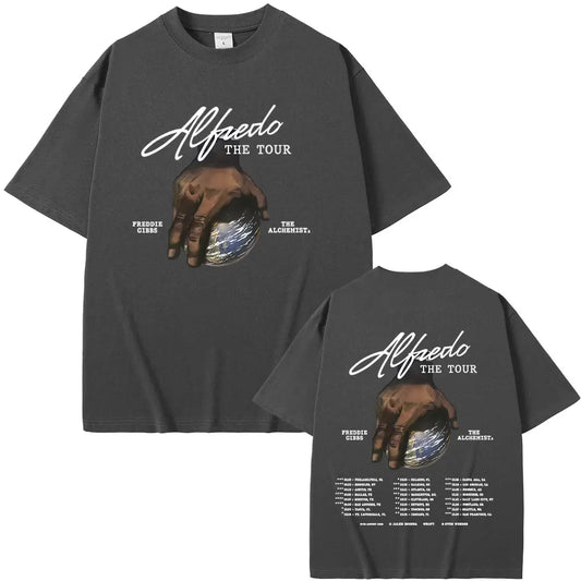 Dark gray oversized t-shirt featuring a hand holding a globe graphic with alfredo the tour and artist names in white script
