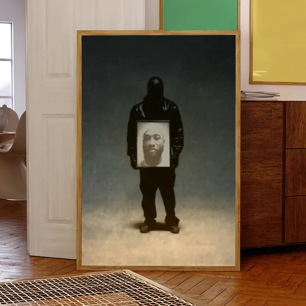 A framed rapper k kanye w west bully album poster print featuring a black silhouette holding a portrait on dark gradient background