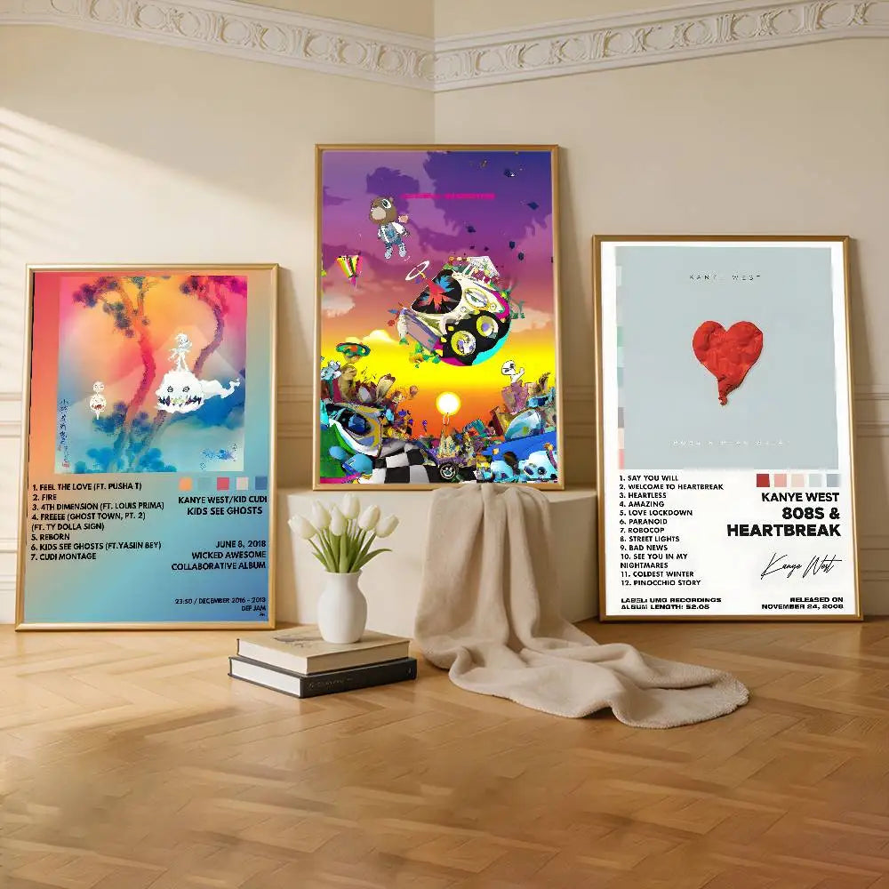 Three gold-framed kanye west music album posters with vibrant artwork and tracklists removable wall decal for commercial decor