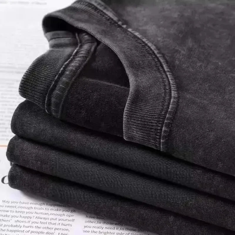 Stack of dark gray cotton ribbed crew neck t-shirts featuring mgk lost americana vintage graphic design