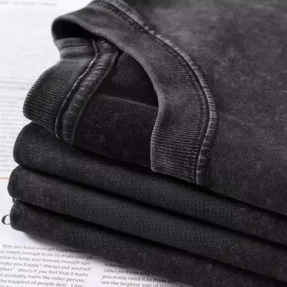 Stack of dark gray cotton ribbed crew neck t-shirts featuring mgk lost americana vintage graphic design