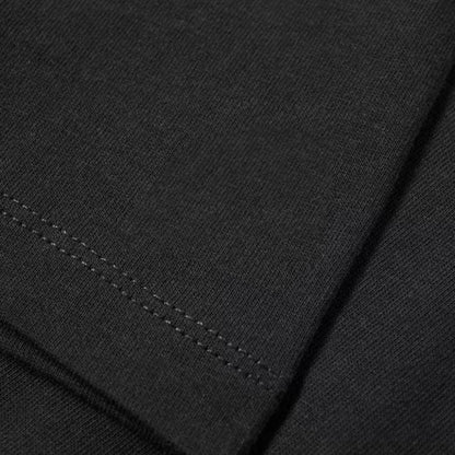 Black ribbed knit fabric with subtle texture and matching stitching on rapper niro vintage cotton fans streetwear unseix tshirt