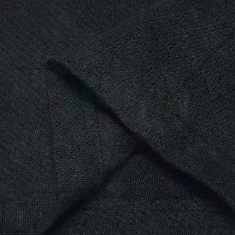 Dark gray textured cotton fabric with subtle greenish hue on fold of rapper plk face oversized fashion pop t shirt vintage hip hop