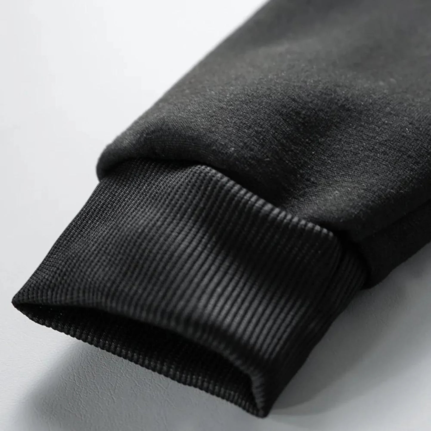 Black ribbed knit cuff on fleece sleeve of rapper quevedo buenas noches vintage casual unisex zip up hoodie