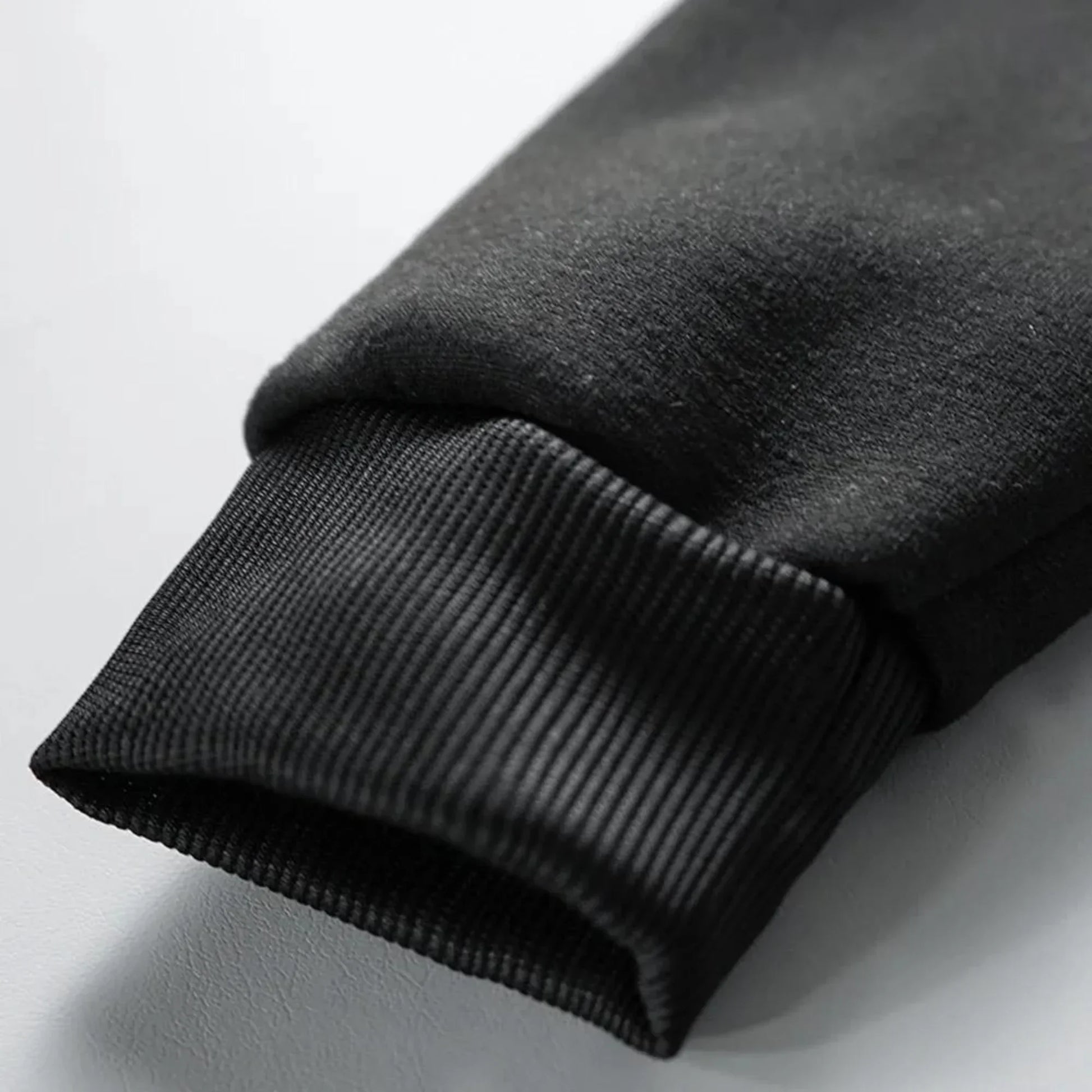 Black ribbed knit cuff on fleece sleeve of rapper quevedo buenas noches vintage casual unisex zip up hoodie