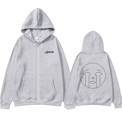 Light gray zip-up hoodie with black embroidered quevedo logo on chest and dotted crying face design on back side
