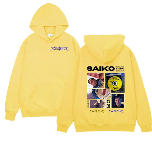 Bright yellow hooded sweatshirt with graphic print of rapper saiko on back and purple script name on chest for hip hop gothic streetwear