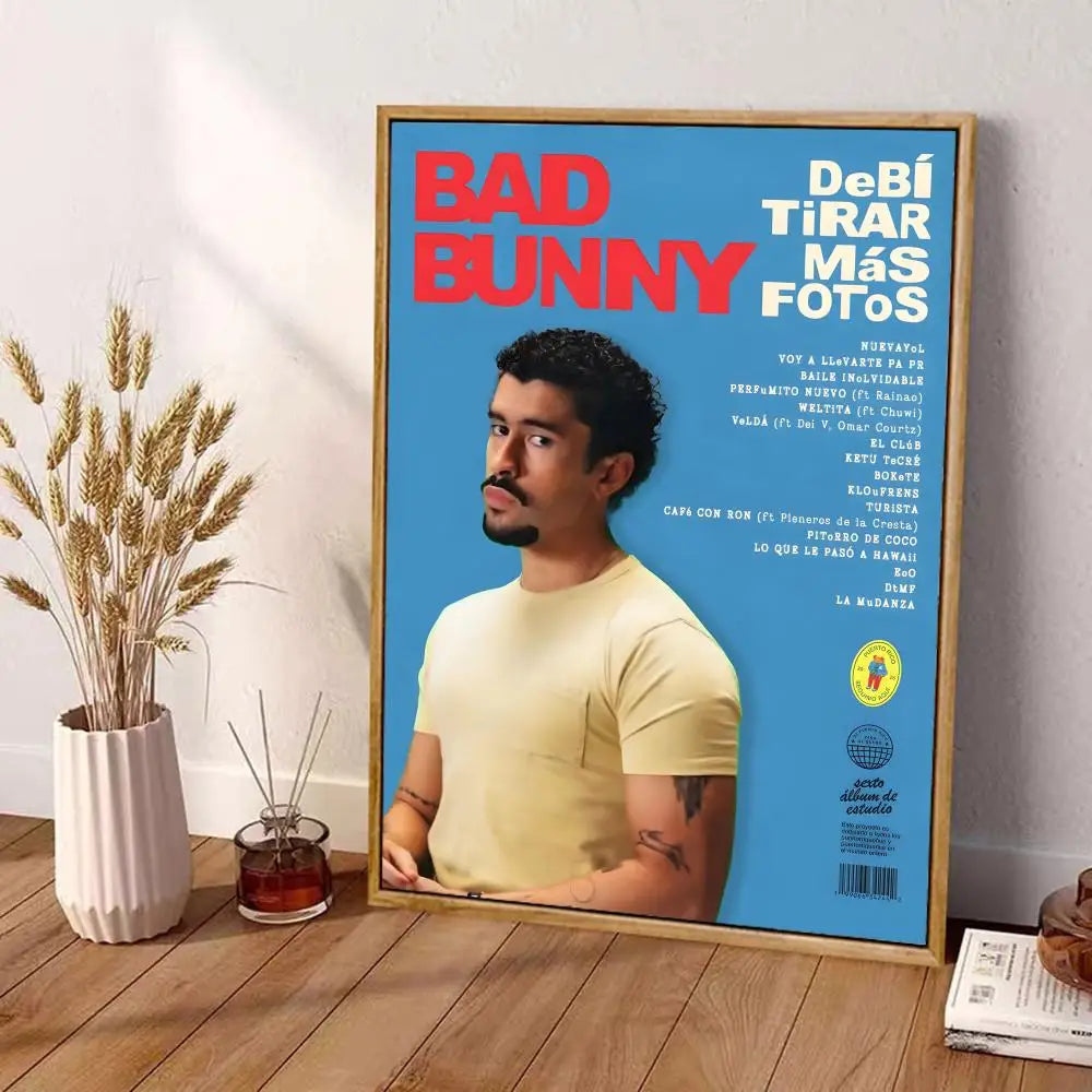 A framed canvas poster of bad bunny in a light yellow t-shirt with bold red text on blue background wall art decor