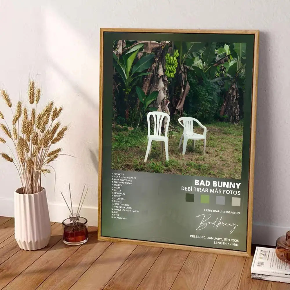 Framed wall art decor featuring white plastic chairs in green outdoor setting with bad bunny album tracklist print