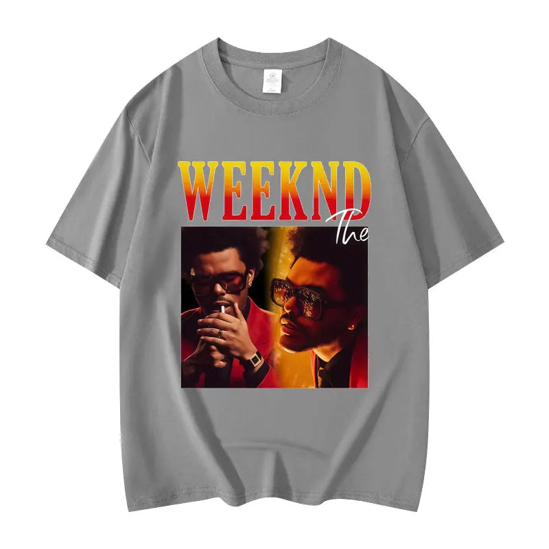 Gray short-sleeved graphic t shirt featuring The Weeknd print with bold yellow to orange lettering in high quality cotton hip hop fashion