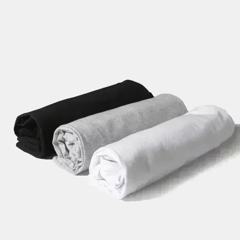 Three rolled-up fleece blankets in black gray and white alongside rapper theodora mega bbl album hip hop fashion t shirt