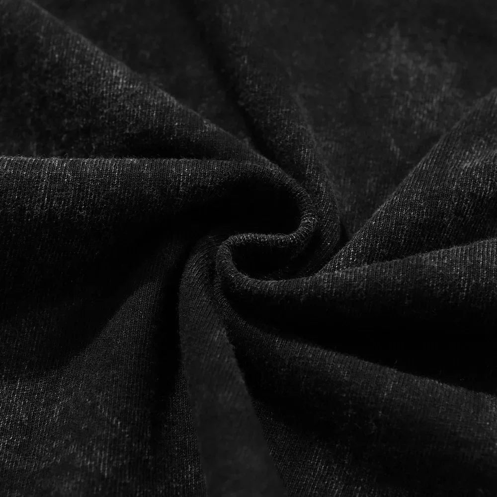 Black textured fabric with subtle sheen and soft wrinkles on rapper yeat lyfestyle vintage washed hip hop fashion t shirt