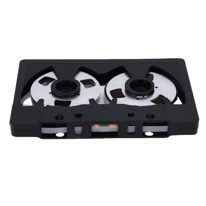 Black plastic reel blank cassette tape with silver spools and orange magnetic strip for sound recording tape use