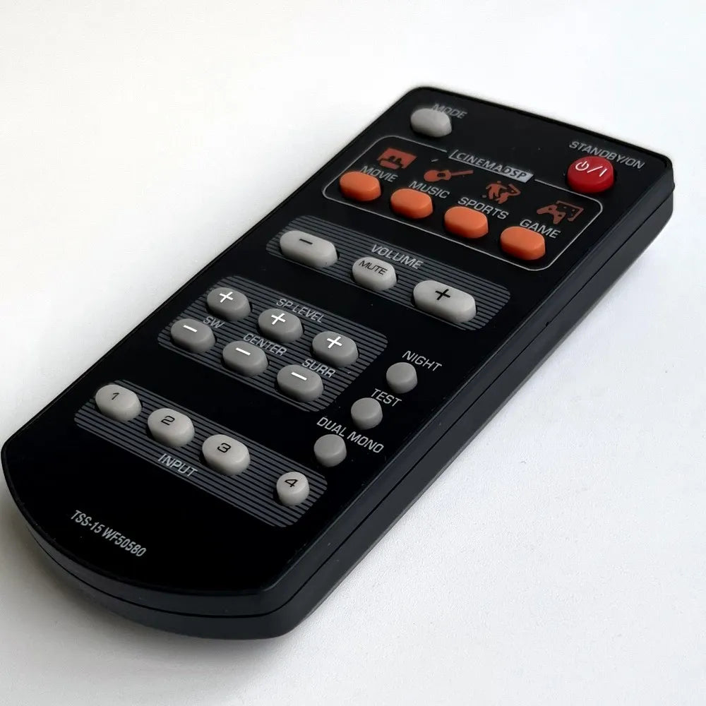 Black plastic remote control with orange and gray buttons and cinema dsp label for yamaha home theater tss-15 wf50580 and tss-20 wn82710