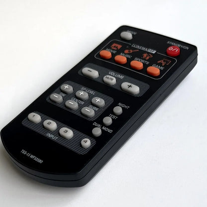 Black plastic remote control with orange and gray buttons and cinema dsp label for yamaha home theater tss-15 wf50580 and tss-20 wn82710
