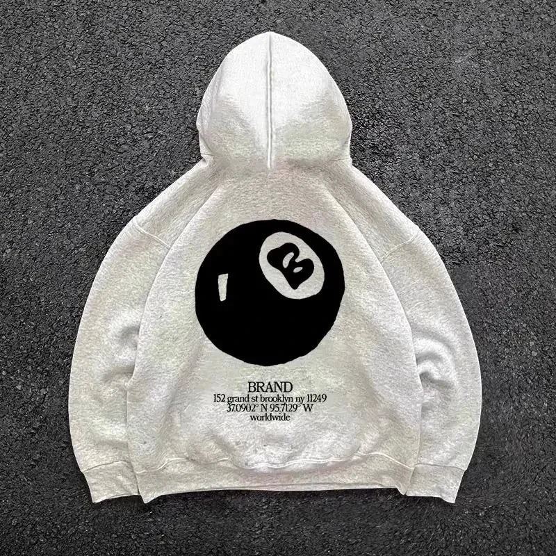 Cream-colored hooded men’s streetwear pullover with large retro 8-ball pattern on the back for casual wear